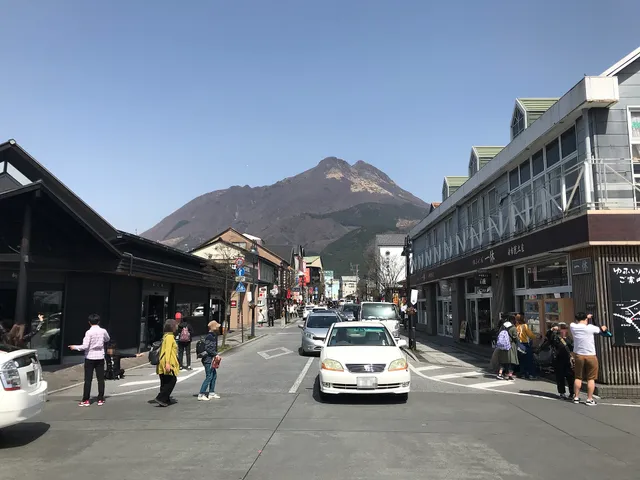The onsen town of Yufuin seen across Kinrin Lake with the twin peaks of Mount Yufu behind