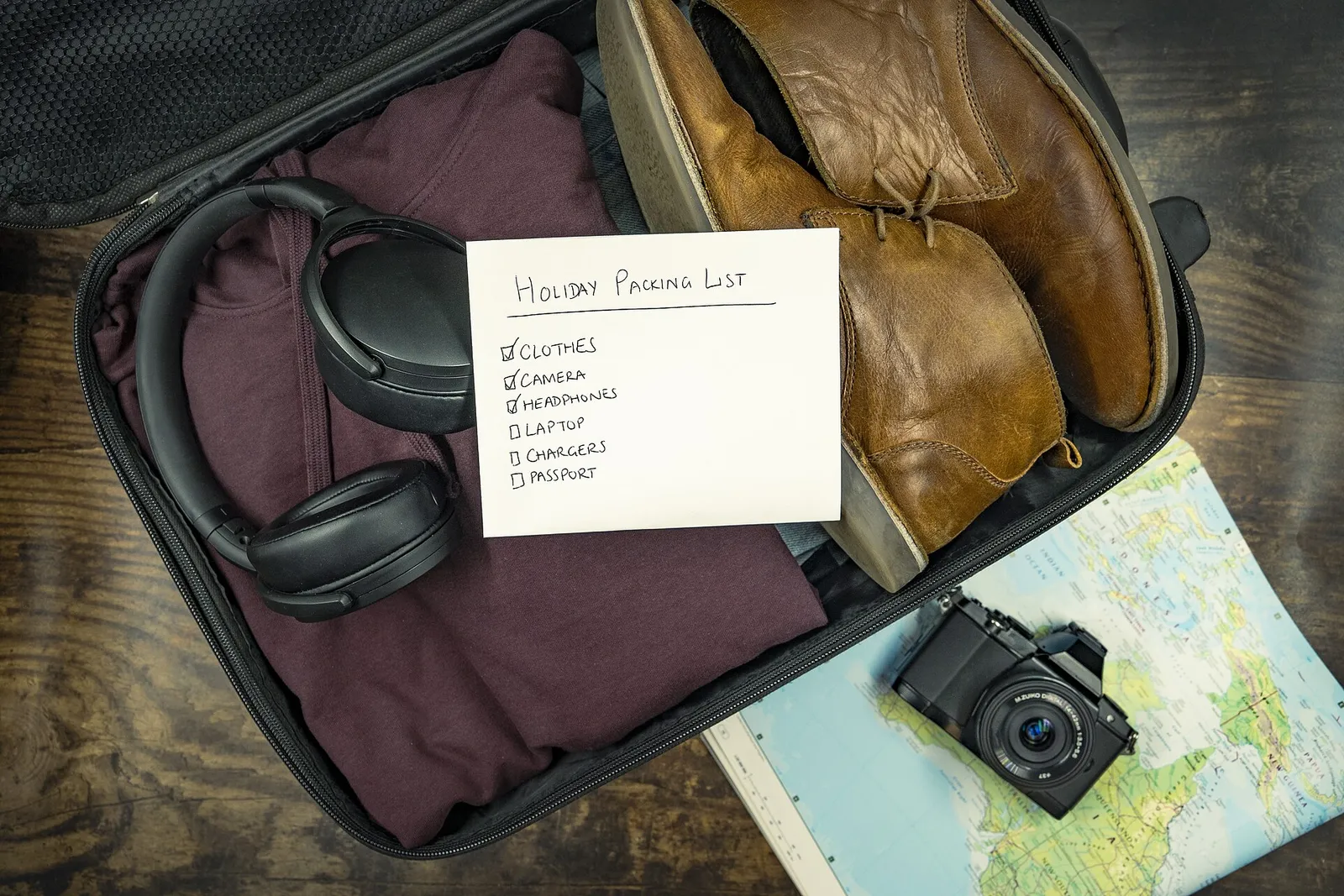 A traveler's packed suitcase and daypack in a hotel room before a day of travel