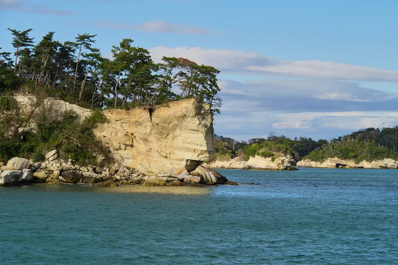 Matsushima Bay seen from the shore, pine-clad islets scattered across calm water