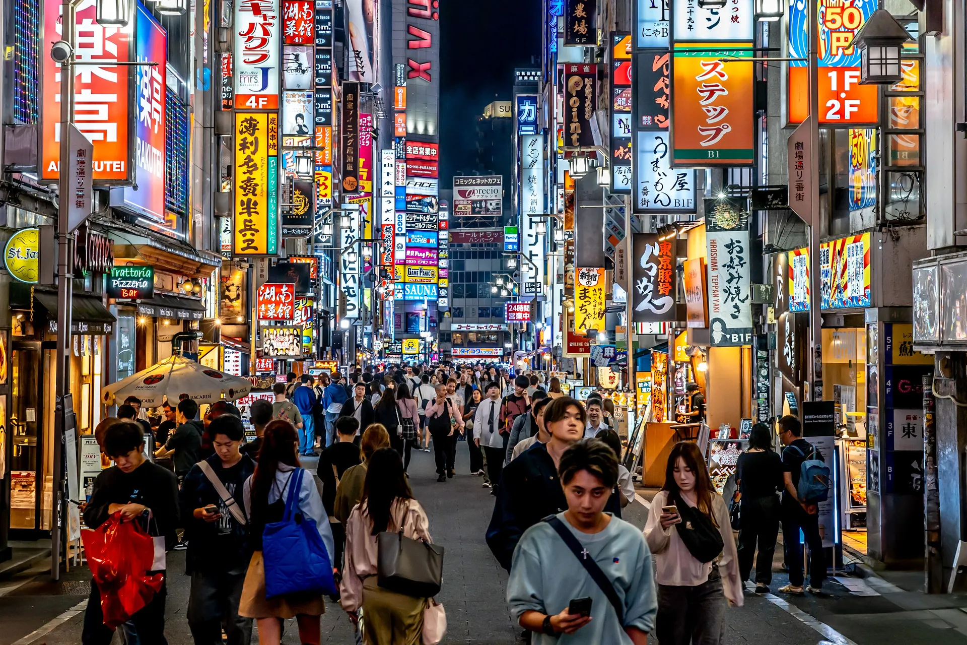 The Shibuya scramble crossing and Tokyo skyline at dusk